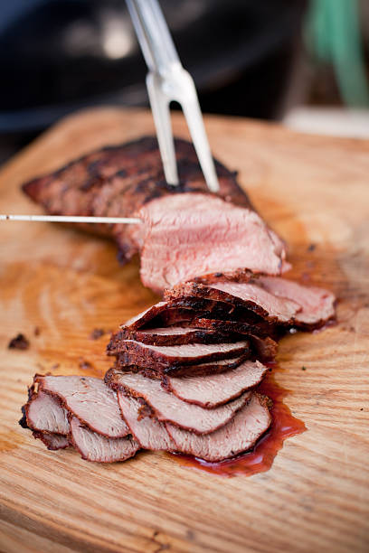 Slices of Grilled Tri-Tip A Santa Maria style tri-tip being cut into slices with a knife and serving fork. santa maria california photos stock pictures, royalty-free photos & images