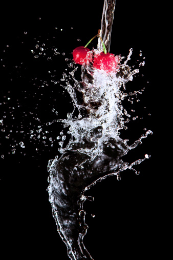 cherries and waters splashes - macro shot
