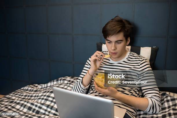 Teenage Boy On Weekend Night Stock Photo - Download Image Now - Teenager, Laziness, Movie