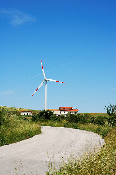 Road to wind turbine stock photo