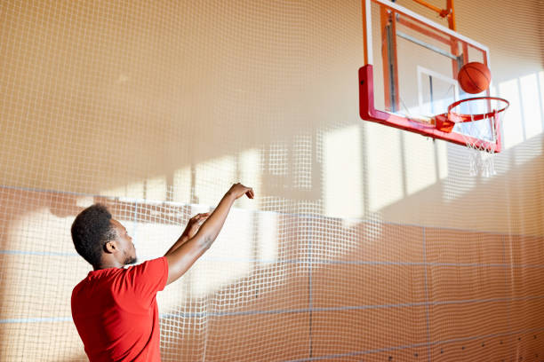 istock Skilled young basketball player training on court 917812710