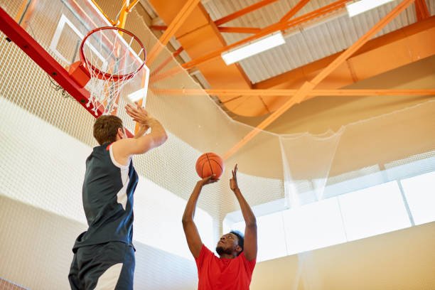 istock Sporty player throwing ball in basket 917812718