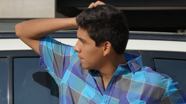 istock Confused Teen Boy And Car 917814142
