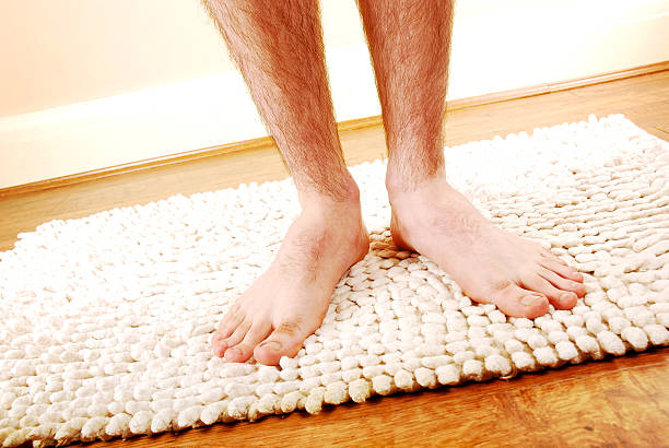 Close up of a man's hairy legs after a shower stock photo