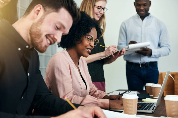 istock Smiling business colleagues working at a table in an office 917815216