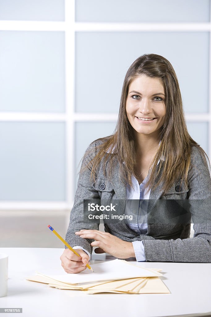 Business Woman Writing notes at desk  Adult Stock Photo