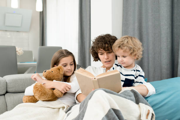 istock Mother Reading Book to Kids 917819948