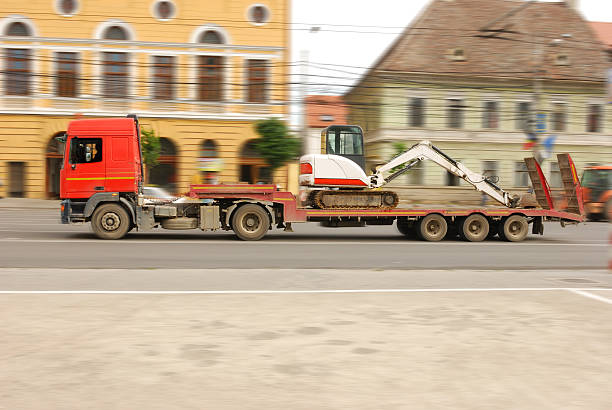 truck carrying construction vehicle