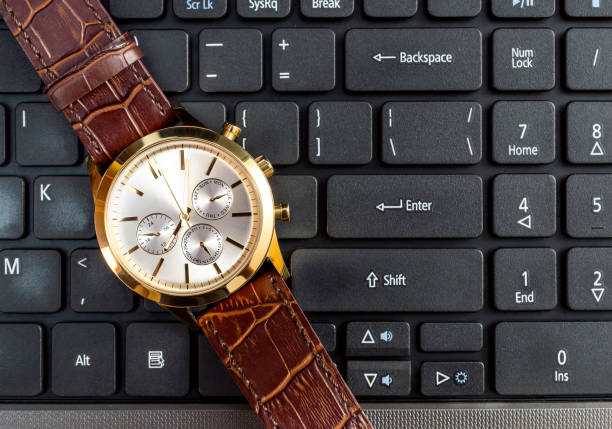 istock Wrist watch on laptop keyboard. Top view. 917821402
