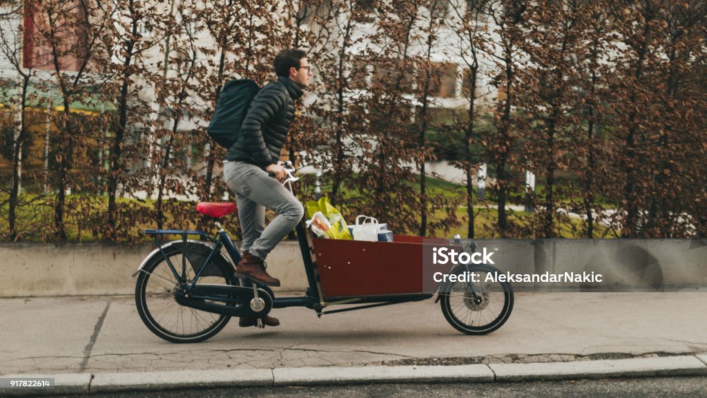 Delivery boy on a cargo bike Cargo Bike Stock Photo