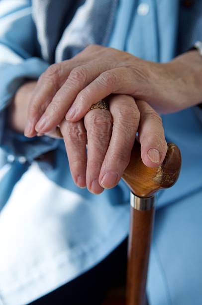 istock Two hands resting in a wooden cane 91782293