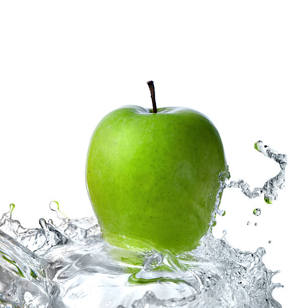 istock fresh water splash and green apple isolated on white 91782365