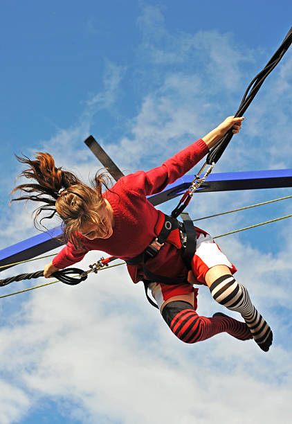 istock Woman in red sweater bungee jumping 91782615