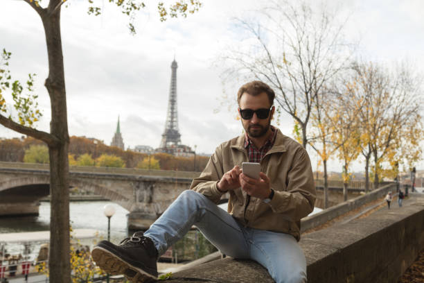 istock Modern guy using cellphone in the European city. 917827410