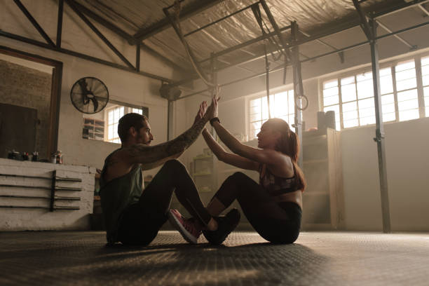 istock Couple exercising together at gym 917832032