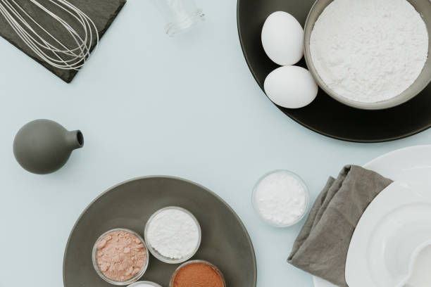 Baking ingredients on pastel background. top view, flat lay, copy space. Milk, flour, sugar, eggs, butter, olive oil, cocoa powder, baking soda, vanilla extract and vinegar Preparation Baking Kitchen Table