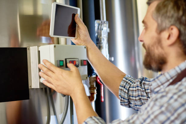 istock Brewing technician setting up equipment at factory 917832588