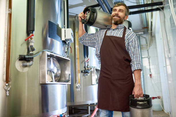 istock Happy excited factory worker carrying beer containers 917832626