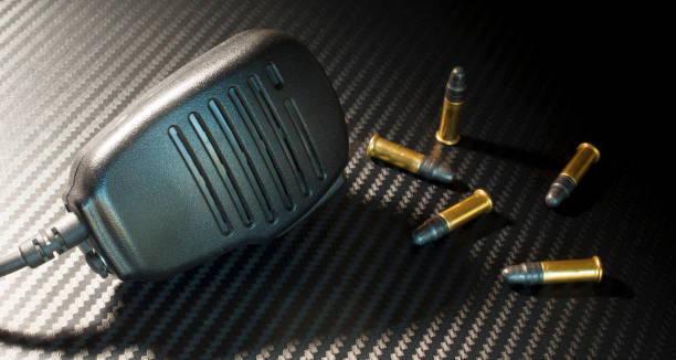 istock Cartridges next to a two way radio microphone 917833400