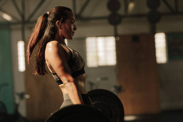 istock Physically fit woman lifting heavy weights 917833992