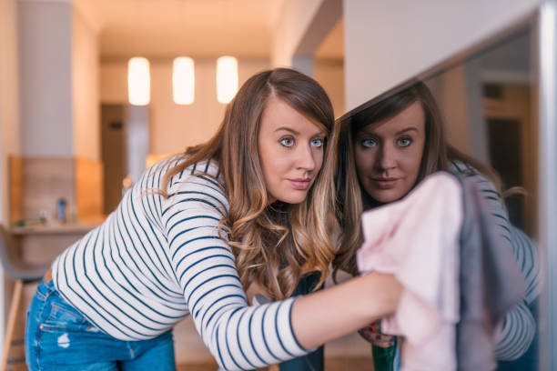 istock Woman cleaning TV 917834210