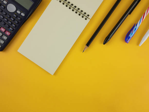 istock Flat lay calculator and stationery on yellow background with copy space 917840976