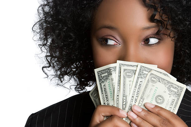 Woman Hiding Behind Money stock photo