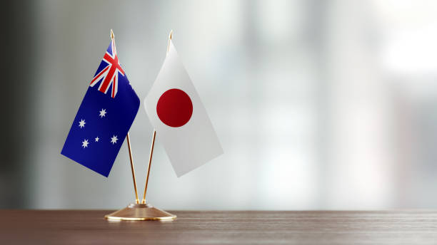 istock Japanese And Australian Flag Pair On A Desk Over Defocused Background 917844534