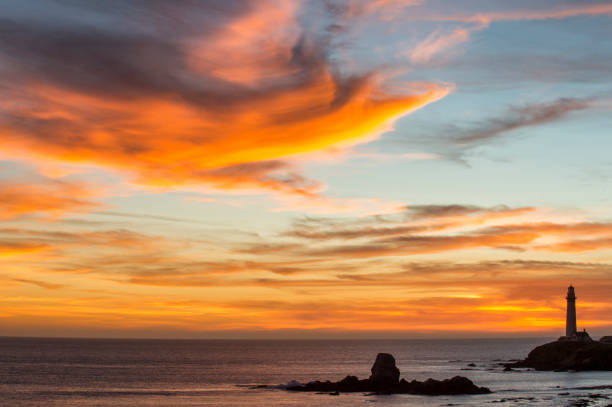 istock Pacific Coast Lighthouse Silhouetted Against Sunset Sky 917852540