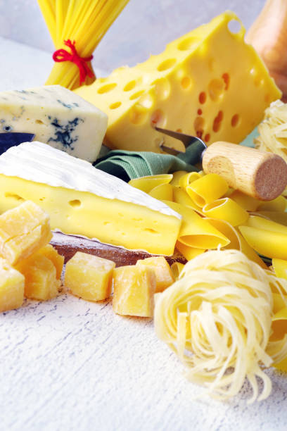istock Pasta and cheese are scattered on a light rustic table. Close-up. 917852686