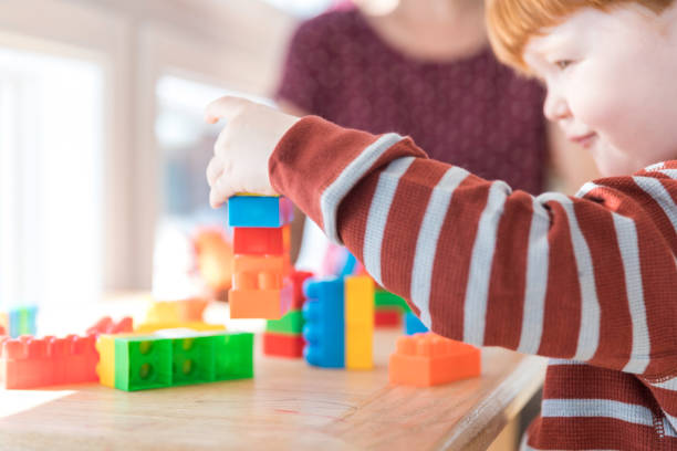 istock Mother and Baby Boy Playing with Colorful Blocks 917852696