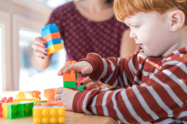istock Mother and Baby Boy Playing with Colorful Blocks 917852850