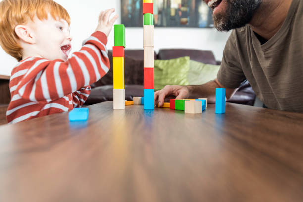istock Father and Baby Boy Playing with Colorful Blocks 917852894