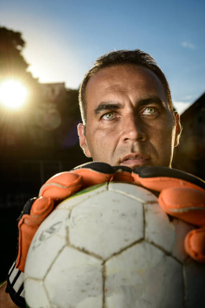 istock Goalkeeper holding a soccer ball 917853260