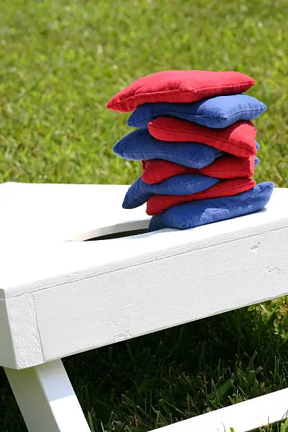 Photo of Cornhole bags stacked on a board