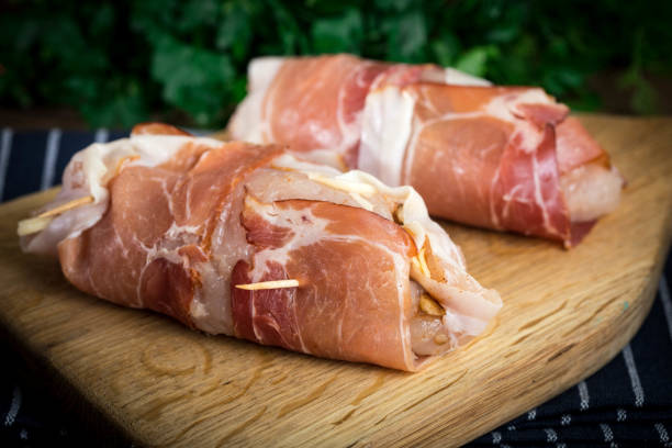 istock Raw chicken breast stuffed with champignon wrapped with bacon. 917857942