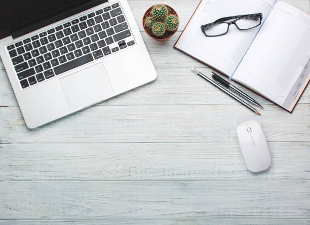 istock Modern workplace on wooden table with a lot of things on it 917859032