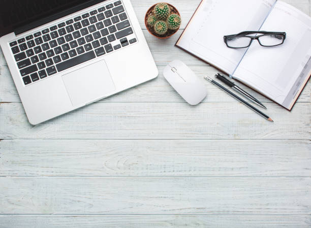 istock Modern workplace on wooden table with a lot of things on it 917859042