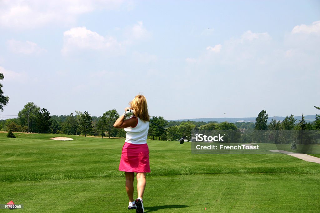 Pretty In Pink Female golfer tees off Adult Stock Photo