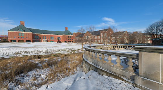 Urbana, Illinois, USA - February 8, 2018: The Bardeen Quadrangle with the Grainger Engineering Library (left) and Mechanical Engineering Laboratory (right) from Boneyard Creek on the campus of the University of Illinois at Urbana-Champaign