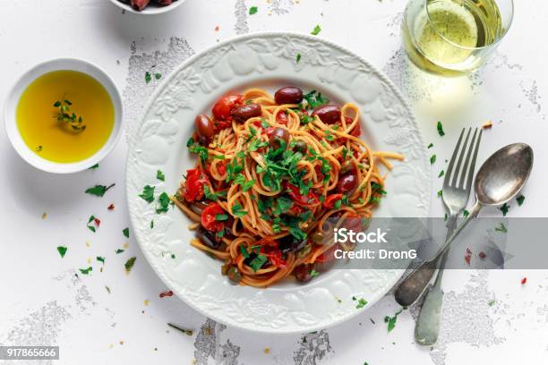 Vegetarian Italian Pasta Alla Puttanesca With Garlic Olives Capers With On White Plate Stock Photo - Download Image Now