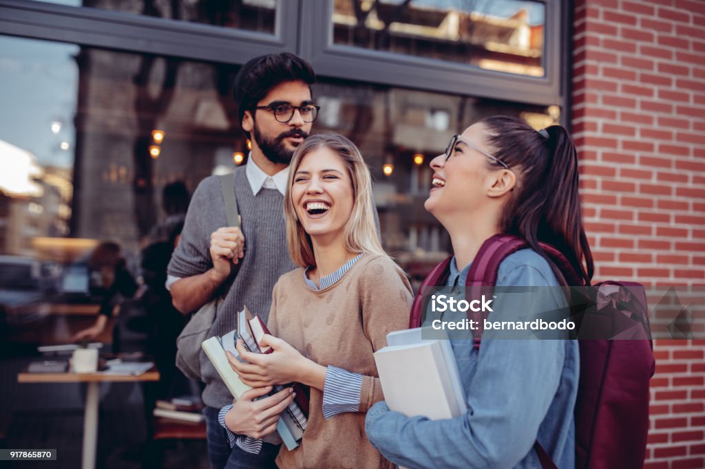 College life is awesome Cropped shot of three happy students talking on the street University Student Stock Photo