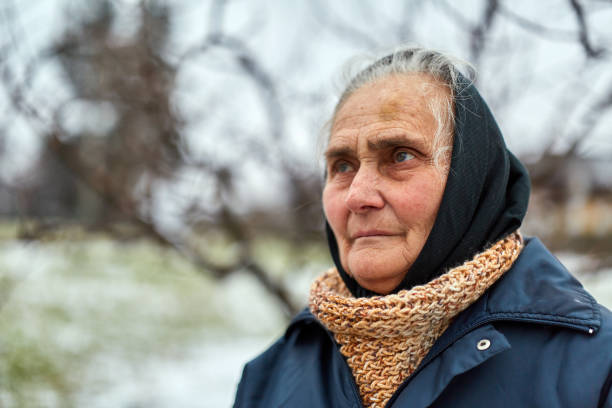 istock Old woman in the countryside 917869978