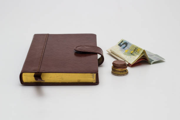istock Note book and Euro banknotes and coins on a white background 917873734
