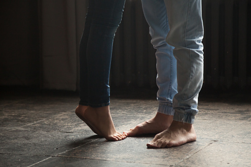 Girl Standing On Tiptoe To Kiss Man Couple Feet Closeup Stock Photo -  Download Image Now - iStock