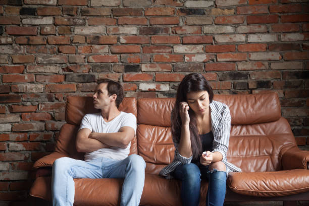 istock Frustrated upset couple after quarrel sitting on sofa at home 917874868