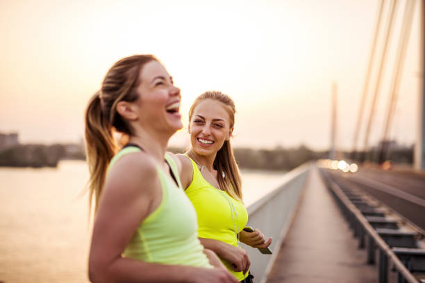 Two female friends jogging on the quayside in Palma de Mallorca in Spain.