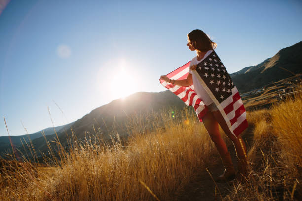 istock Young Woman with American Flag 917877444