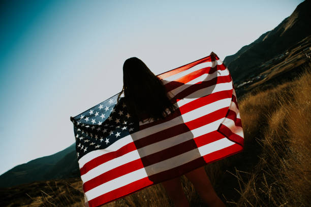 istock Young Woman with American Flag 917877596