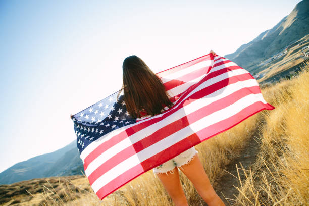 istock Young Woman with American Flag 917877766